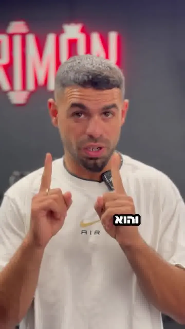 Rimon gym coach talking to camera in front of the neon Rimon sign